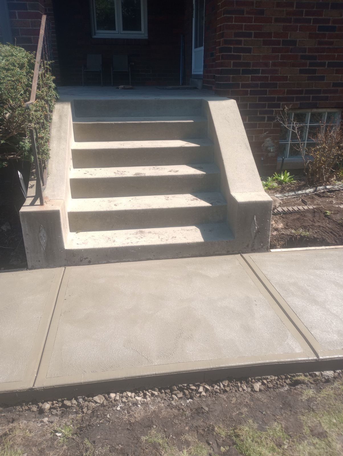 Front entry concrete steps and pad