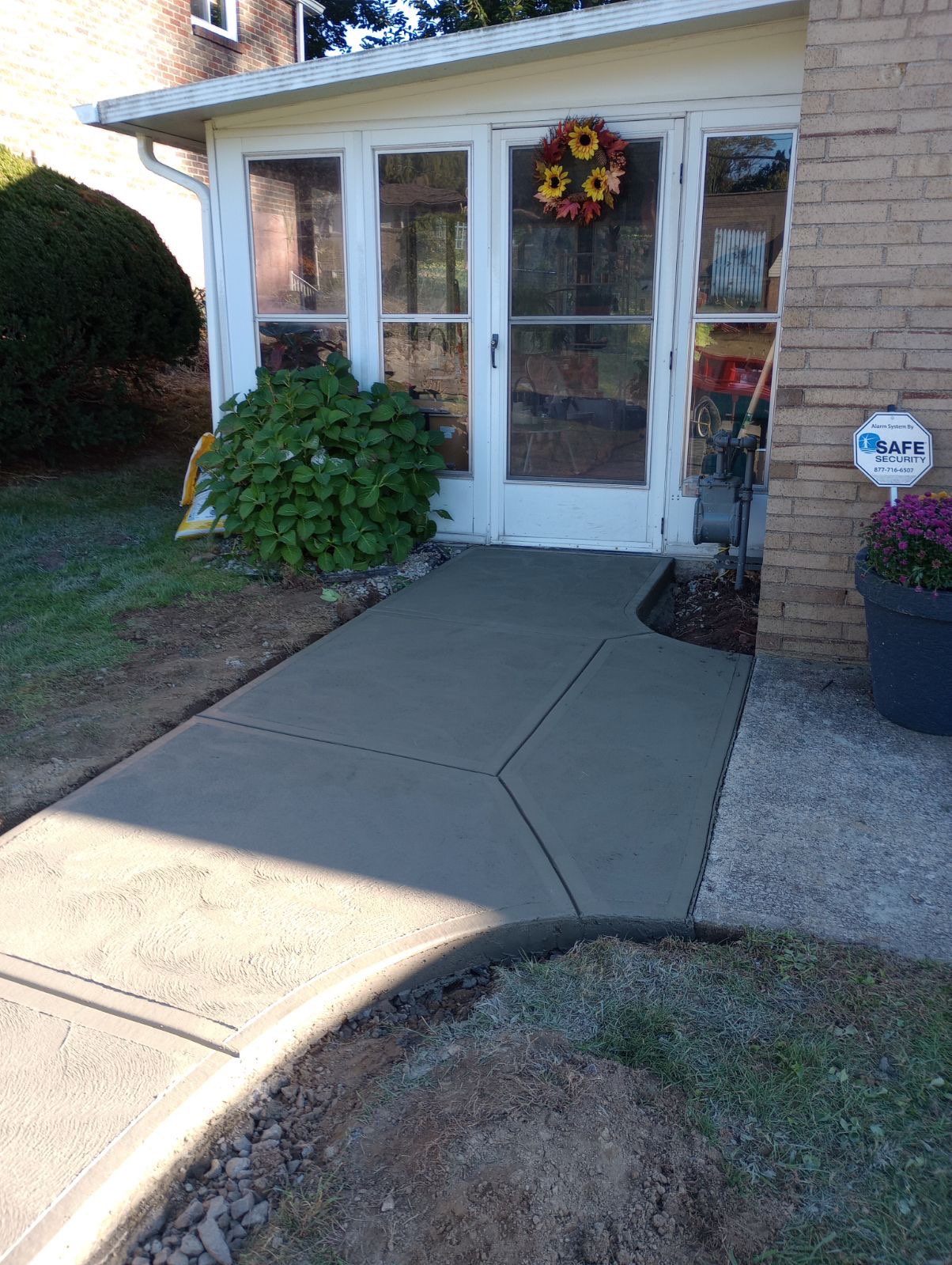 Concrete patio at a sunroom entry